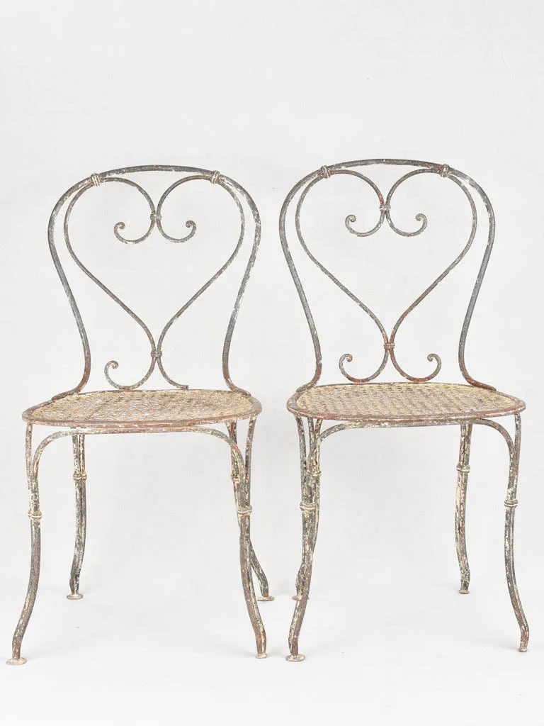 Pair of antique heart back garden chairs